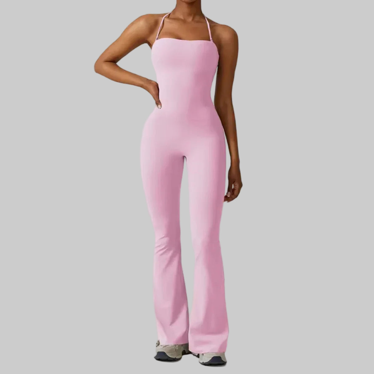 Person wearing a pink jumpsuit on a plain background with 'CTENKEVET' branding.